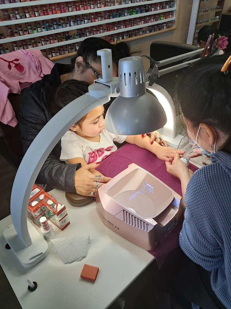 A young guest enjoying her first manicure at Spa Nails
