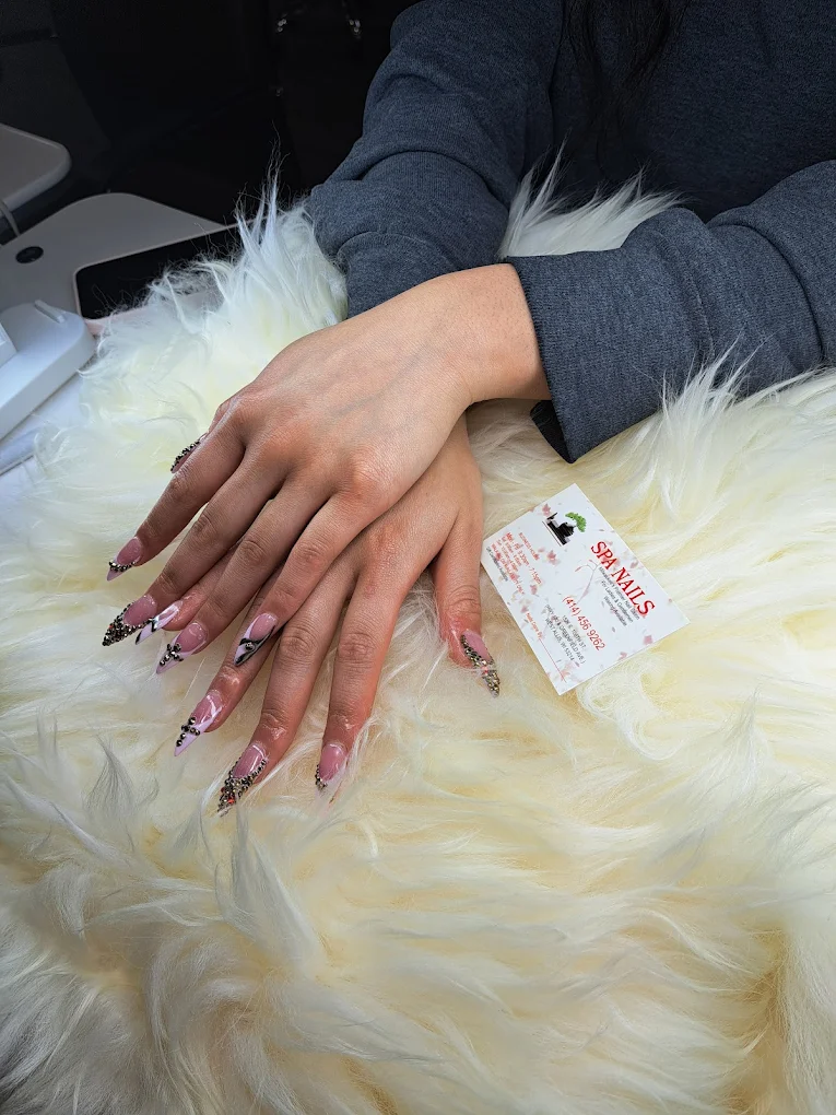 Stiletto nails with French tips and crystal accents at Spa Nails
